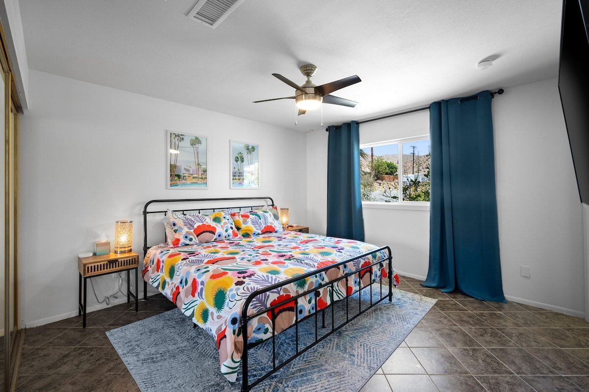 King bedroom with floral bedding and Palm Springs prints